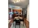 The kitchen has wooden cabinets, a central island, hardwood floors, and stainless-steel appliances at 6432 Polar Fox Ct, Riverdale, GA 30296