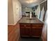 Kitchen island with wooden cabinets and dark countertop in open-concept design, connecting to dining area at 6432 Polar Fox Ct, Riverdale, GA 30296
