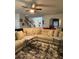 Spacious living room featuring a sectional sofa, modern decor, and a view of the open floor plan at 6432 Polar Fox Ct, Riverdale, GA 30296