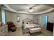 A large main bedroom boasts a ceiling fan, sitting area, and plenty of space at 6432 Polar Fox Ct, Riverdale, GA 30296