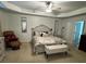Spacious main bedroom with neutral colors, bench and fan lighting at 6432 Polar Fox Ct, Riverdale, GA 30296