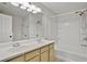 Bathroom featuring double sink vanity and shower-tub combo at 1384 Dolcetto Nw Trce, Kennesaw, GA 30152