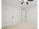 Bright bedroom featuring a ceiling fan and a double door closet, offering organized storage solutions at 1384 Dolcetto Nw Trce, Kennesaw, GA 30152