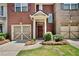 Attractive brick townhome with a one-car garage and inviting front entrance at 1384 Dolcetto Nw Trce, Kennesaw, GA 30152