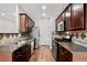 Beautiful kitchen featuring stainless appliances and lots of dark wood cabinetry at 1384 Dolcetto Nw Trce, Kennesaw, GA 30152