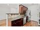 View of stainless appliances, decorative tile backsplash, and dark wood cabinetry at 1384 Dolcetto Nw Trce, Kennesaw, GA 30152