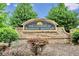 The Landings at Kennesaw Mountain entrance sign with brick base and lush greenery at 1384 Dolcetto Nw Trce, Kennesaw, GA 30152