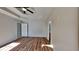 Main bedroom with hardwood floors, tray ceilings, a ceiling fan, and plenty of light at 145 Charleston Pl, Covington, GA 30016