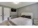This bedroom has ample natural light, a television, and neutral colored walls at 1548 Station Ridge Dr, Lawrenceville, GA 30045