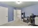 Cozy bedroom with blue walls, a white door, and an open doorway to a hallway at 1548 Station Ridge Dr, Lawrenceville, GA 30045