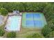 Aerial photo of the community pool and tennis courts, surrounded by lush trees at 1548 Station Ridge Dr, Lawrenceville, GA 30045