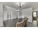 Open dining room with wood flooring and a chandelier, adjacent to another living space at 1548 Station Ridge Dr, Lawrenceville, GA 30045