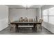 Elegant dining room with dark wood table, seating for six, and modern chandelier lighting at 1548 Station Ridge Dr, Lawrenceville, GA 30045