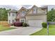 Charming two-story home featuring a manicured lawn, brick accents, and an attached two-car garage at 1548 Station Ridge Dr, Lawrenceville, GA 30045
