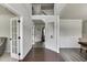 Bright hallway with hardwood floors, white trim, and a staircase leading to the upper level at 1548 Station Ridge Dr, Lawrenceville, GA 30045