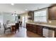 Open kitchen features stainless steel appliances, dark cabinets and a view to the living room at 1548 Station Ridge Dr, Lawrenceville, GA 30045