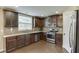 Kitchen featuring stainless steel appliances and dark hardwood floors at 1548 Station Ridge Dr, Lawrenceville, GA 30045