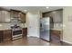 Kitchen featuring dark cabinets, stainless steel appliances, and granite countertops at 1548 Station Ridge Dr, Lawrenceville, GA 30045