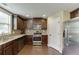Well-lit kitchen with stainless steel appliances and dark cabinets at 1548 Station Ridge Dr, Lawrenceville, GA 30045