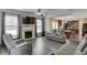 Spacious living room with reclining seating, fireplace and tv, and seamless flow into the kitchen at 1548 Station Ridge Dr, Lawrenceville, GA 30045
