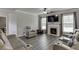 Bright living area with reclining seating, a cozy fireplace, and hardwood flooring at 1548 Station Ridge Dr, Lawrenceville, GA 30045