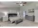 Spacious main bedroom featuring a ceiling fan, ensuite bathroom, and neutral color palette at 1548 Station Ridge Dr, Lawrenceville, GA 30045
