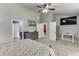 Bright main bedroom with plush carpet, ensuite bathroom, and a large television for entertainment at 1548 Station Ridge Dr, Lawrenceville, GA 30045