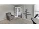 Comfortable room featuring a gray chair, tree-shaped shelves, and glass-paneled doors at 1548 Station Ridge Dr, Lawrenceville, GA 30045