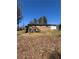 A spacious backyard view with a wooden deck attached to the house at 2103 River Rd, Ellenwood, GA 30294