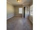Cozy bedroom featuring neutral carpet, walls, window, and a closet for easy organization at 2103 River Rd, Ellenwood, GA 30294