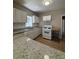 Bright kitchen with white cabinets, granite counters, and a movable island at 2103 River Rd, Ellenwood, GA 30294