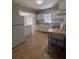 Functional kitchen with white cabinets, neutral backsplash, and standard appliances at 2103 River Rd, Ellenwood, GA 30294