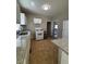 Bright kitchen with white cabinets, granite counters, standard appliances, and a movable island at 2103 River Rd, Ellenwood, GA 30294