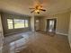 Cozy living room with a ceiling fan, large windows, and neutral-toned walls at 2103 River Rd, Ellenwood, GA 30294