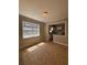 Open-concept living room with tile flooring and natural light from a large window overlooking the lush greenery at 2103 River Rd, Ellenwood, GA 30294