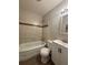 Tiled bathroom features a bathtub, toilet and sink at 2830 Norgate Ln, Decatur, GA 30034
