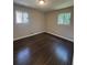 This is an empty bedroom with hardwood flooring and two windows at 2830 Norgate Ln, Decatur, GA 30034