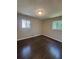 This is an empty bedroom with hardwood flooring and two windows at 2830 Norgate Ln, Decatur, GA 30034