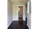 Hallway to laundry room with dark wood floors and light beige walls at 2830 Norgate Ln, Decatur, GA 30034