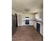 Modern kitchen features sleek white cabinets, granite countertops, stainless steel appliances and wood-look floors at 2830 Norgate Ln, Decatur, GA 30034