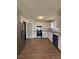 Modern kitchen features sleek white cabinets, granite countertops, stainless steel appliances and wood-look floors at 2830 Norgate Ln, Decatur, GA 30034