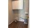 Laundry room with white cabinets and wood flooring at 2830 Norgate Ln, Decatur, GA 30034