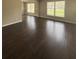 Spacious living room featuring gleaming hardwood floors and large windows that flood the space with natural light at 2830 Norgate Ln, Decatur, GA 30034