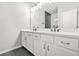 Bright bathroom featuring a double vanity with white cabinets, dark hardware, and modern finishes at 772 Aerial Se Way, Atlanta, GA 30312