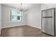 Bright dining area with stylish lighting fixture, stainless fridge, and windows at 772 Aerial Se Way, Atlanta, GA 30312