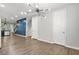 Open-concept dining room with modern chandelier and wood-look flooring at 772 Aerial Se Way, Atlanta, GA 30312