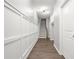 Well-lit hallway with wood floors, wainscoting, and staircase leading to the upper level at 772 Aerial Se Way, Atlanta, GA 30312