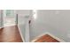 Upper level hallway with hardwood floors and white trim, offering a clean and bright transition space at 772 Aerial Se Way, Atlanta, GA 30312