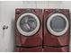 Laundry room showcasing modern red front-loading washer and dryer units at 772 Aerial Se Way, Atlanta, GA 30312