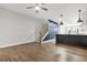 Open-concept living space with hardwood floors, leading to the kitchen and featuring a stylish staircase at 772 Aerial Se Way, Atlanta, GA 30312